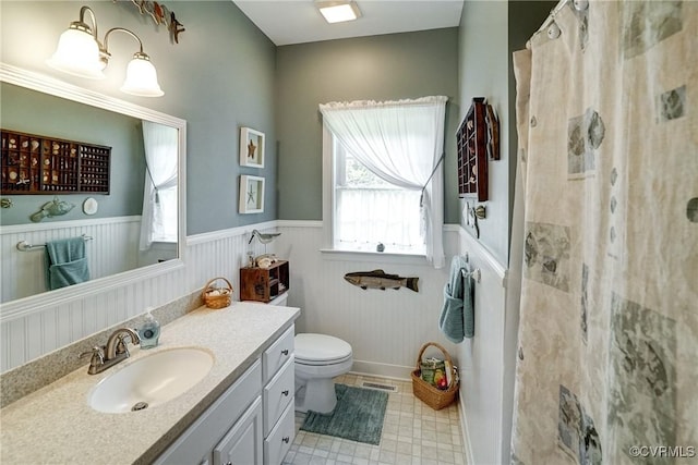 423 Elm Creek Dr, Manakin Sabot, VA 23103 - bathroom with vanity, a shower with shower curtain, a wainscoted wall, and toilet