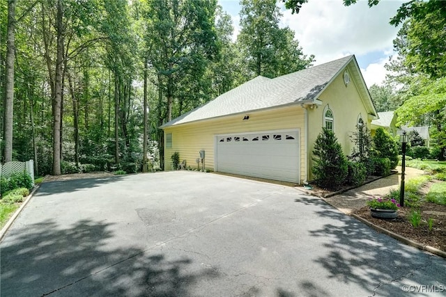 423 Elm Creek Dr, Manakin Sabot, VA 23103 - view of home's exterior featuring stucco siding, concrete driveway, and an attached garage
