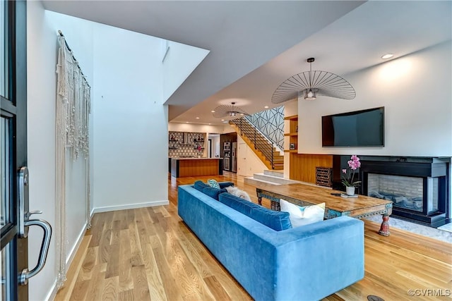 26171/2 Floyd Ave, Richmond, VA 23220 - living room with stairs, a fireplace, wood finished floors, and recessed lighting