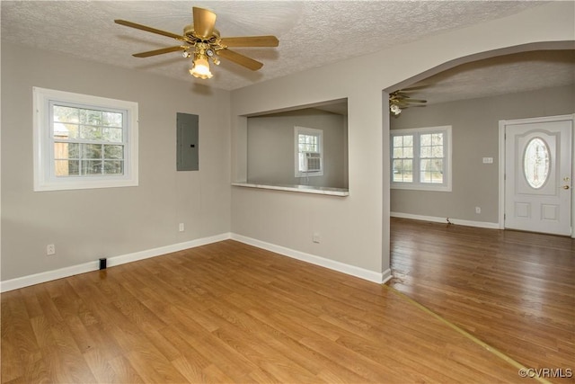 11512 Duncan Rd, Dinwiddie, VA 23805 - unfurnished room featuring ceiling fan, electric panel, arched walkways, a textured ceiling, and wood finished floors