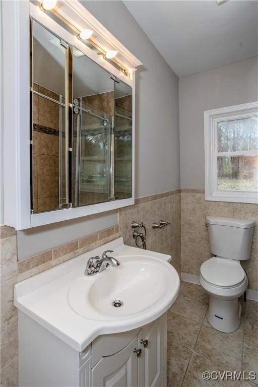 11512 Duncan Rd, Dinwiddie, VA 23805 - bathroom with tile walls, vanity, toilet, a tile shower, and tile patterned floors