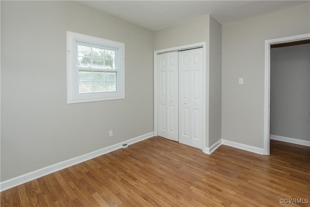 11512 Duncan Rd, Dinwiddie, VA 23805 - unfurnished bedroom with light wood-style flooring, baseboards, and a closet