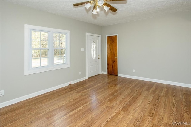 11512 Duncan Rd, Dinwiddie, VA 23805 - empty room with a ceiling fan, light wood finished floors, baseboards, and a textured ceiling