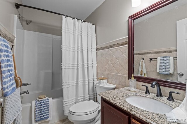 1716 First Colonial Ct, Richmond, VA 23231 - bathroom featuring tile walls, vanity, toilet, shower / bath combination with curtain, and a wainscoted wall