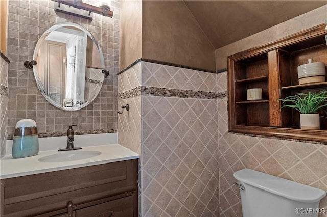 1716 First Colonial Ct, Richmond, VA 23231 - half bathroom featuring tile walls, vanity, toilet, and vaulted ceiling