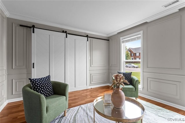 1716 First Colonial Ct, Richmond, VA 23231 - living area featuring a decorative wall, a barn door, ornamental molding, and wood finished floors