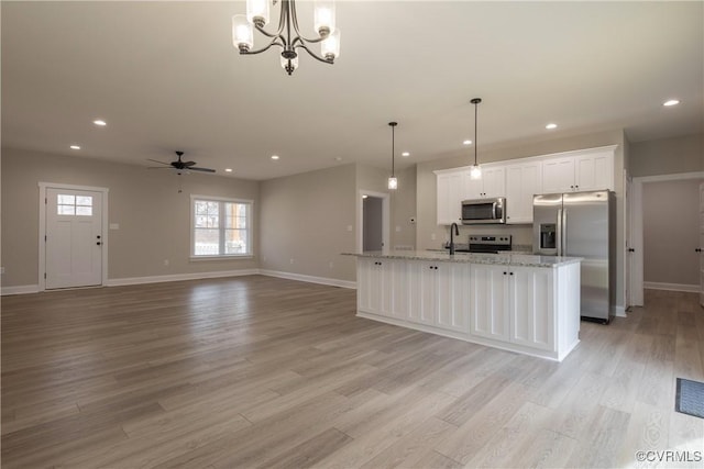 74 Paddock Ln, Louisa, VA 23093 - kitchen with appliances with stainless steel finishes, light wood finished floors, white cabinets, baseboards, and recessed lighting