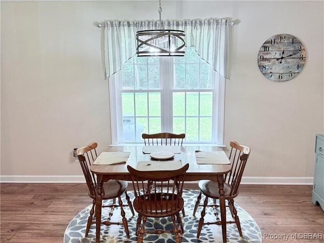 1205 Trimmers Shop Rd, West Point, VA 23181 - dining room with wood finished floors, baseboards, and a chandelier