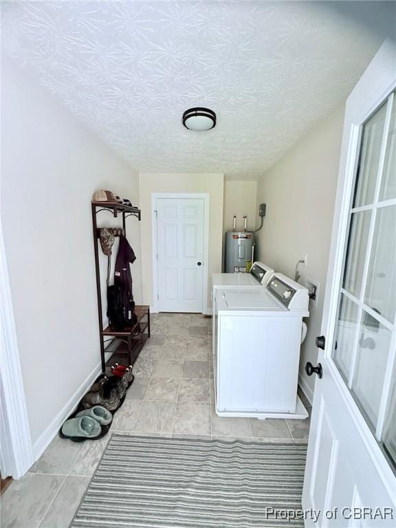 1205 Trimmers Shop Rd, West Point, VA 23181 - laundry room featuring independent washer and dryer, baseboards, a textured ceiling, and electric water heater
