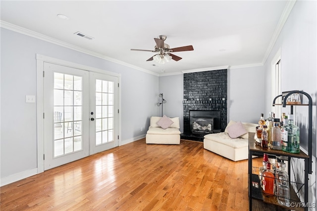 119 Monath Rd, Richmond, VA 23236 - living area featuring french doors, light wood finished floors, ceiling fan, ornamental molding, and a fireplace