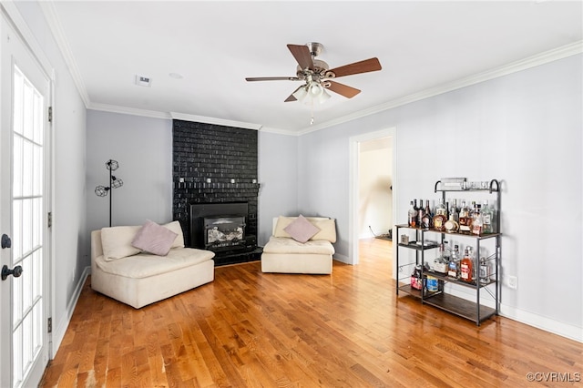 119 Monath Rd, Richmond, VA 23236 - living area with light wood-type flooring, a fireplace, a ceiling fan, crown molding, and a bar
