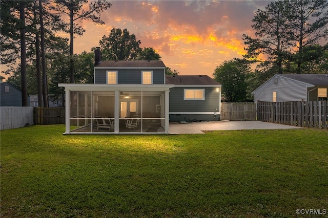 119 Monath Rd, Richmond, VA 23236 - back of house at dusk with a sunroom, a fenced backyard, a patio, and a chimney