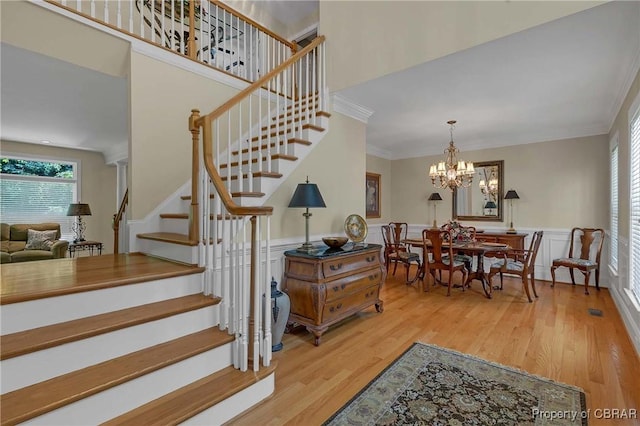 1708 Centennial Dr, Toano, VA 23168 - stairs with plenty of natural light, wood finished floors, crown molding, a chandelier, and wainscoting
