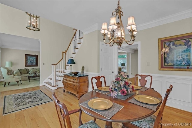 1708 Centennial Dr, Toano, VA 23168 - dining space featuring a chandelier, wood finished floors, crown molding, stairway, and a wainscoted wall