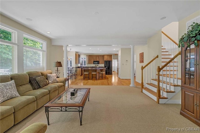 1708 Centennial Dr, Toano, VA 23168 - living room with decorative columns, stairs, light carpet, and recessed lighting