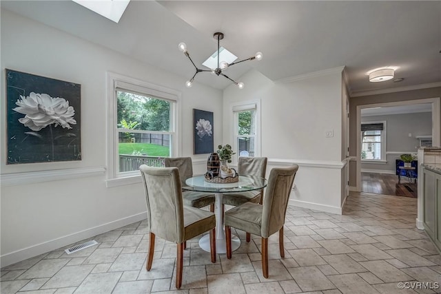 1537 Winbury Dr, Midlothian, VA 23114 - dining area with a chandelier, ornamental molding, vaulted ceiling, and a skylight