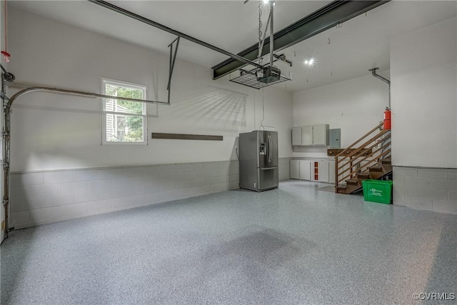 1537 Winbury Dr, Midlothian, VA 23114 - garage with stainless steel fridge with ice dispenser, concrete block wall, a garage door opener, and electric panel