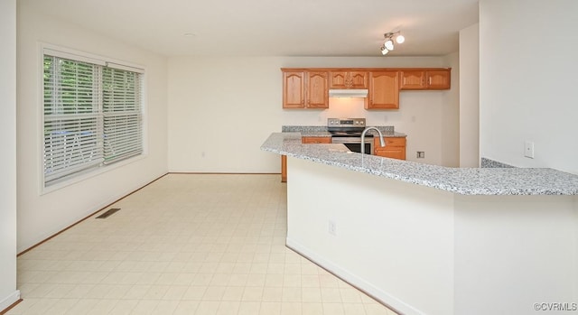833 Tavern Green Rd, Glen Allen, VA 23060 - kitchen with stainless steel range with electric cooktop, light stone counters, under cabinet range hood, and baseboards