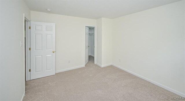 833 Tavern Green Rd, Glen Allen, VA 23060 - unfurnished bedroom featuring light colored carpet, baseboards, a walk in closet, and a closet