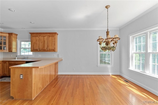 12055 Hadden Hall Dr, Chesterfield, VA 23838 - kitchen featuring light wood-style floors, a peninsula, brown cabinetry, glass insert cabinets, and light countertops