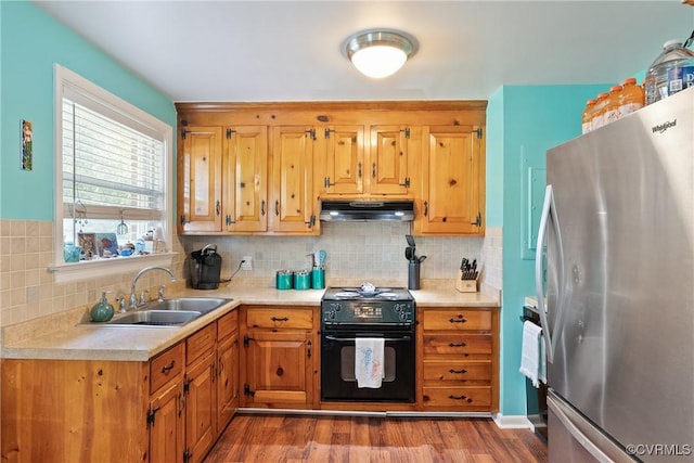 7143 Cherry Ln, Mechanicsville, VA 23111 - kitchen featuring freestanding refrigerator, stove, a sink, under cabinet range hood, and light countertops