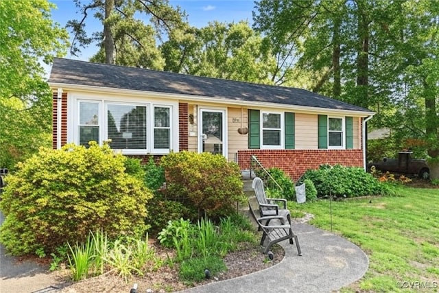 7143 Cherry Ln, Mechanicsville, VA 23111 - view of front facade with a front yard and brick siding