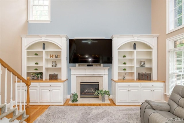 11407 Timber Point Dr, Chesterfield, VA 23838 - living area with light wood-style flooring, healthy amount of natural light, stairs, a high ceiling, and a fireplace