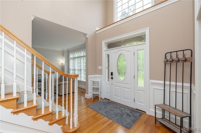11407 Timber Point Dr, Chesterfield, VA 23838 - foyer entrance featuring wainscoting, wood finished floors, stairway, ornamental molding, and a decorative wall