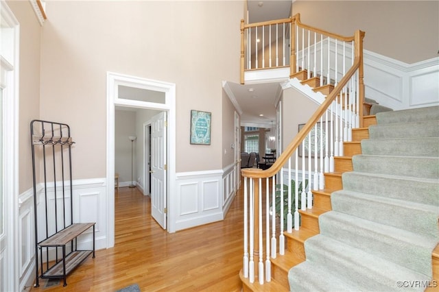 11407 Timber Point Dr, Chesterfield, VA 23838 - stairs with a decorative wall, wood finished floors, wainscoting, and a high ceiling