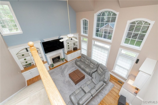 11407 Timber Point Dr, Chesterfield, VA 23838 - living area featuring a high ceiling, ceiling fan, a fireplace with flush hearth, and wood finished floors