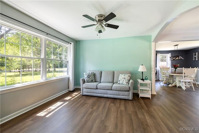 16701 Jolly Rd, Prince George, VA 23842 - living area featuring baseboards, dark wood-style flooring, ceiling fan, and arched walkways