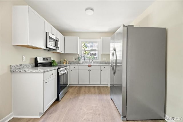 12 Wheelhouse Ct, Petersburg, VA 23805 - kitchen featuring appliances with stainless steel finishes, light wood finished floors, white cabinets, and light stone countertops