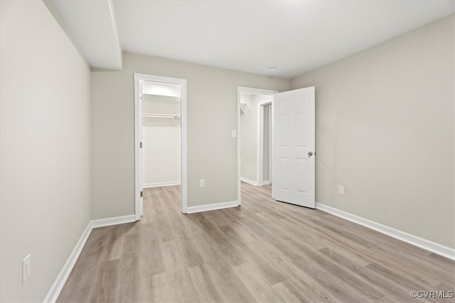 12 Wheelhouse Ct, Petersburg, VA 23805 - unfurnished bedroom featuring light wood-type flooring, a spacious closet, and a closet