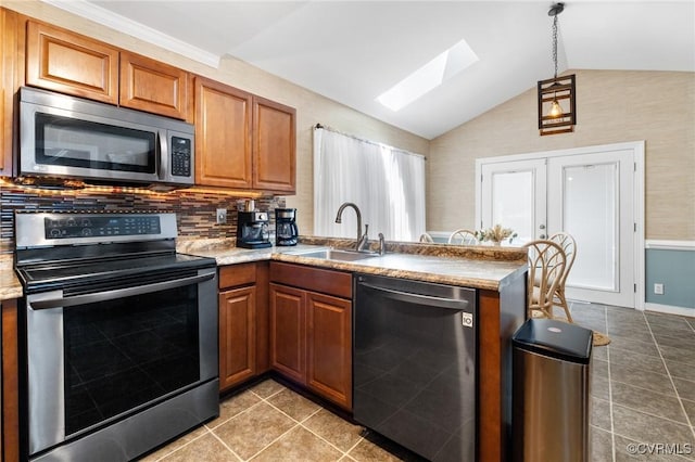12912 Cottage Mill Pl, Midlothian, VA 23114 - kitchen featuring appliances with stainless steel finishes, a sink, lofted ceiling, a skylight, and brown cabinets