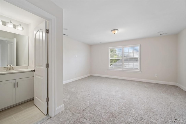 6800 Alabaster Ln, Chesterfield, VA 23234 - empty room featuring a sink, baseboards, and light colored carpet