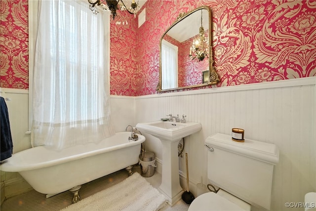323 N 27th St, Richmond, VA 23223 - bathroom with wallpapered walls, a wainscoted wall, and a soaking tub