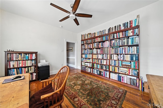 323 N 27th St, Richmond, VA 23223 - home office featuring ceiling fan, wood finished floors, and bookshelves