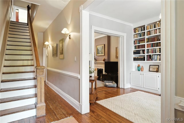 323 N 27th St, Richmond, VA 23223 - stairs featuring hardwood / wood-style flooring, built in features, and crown molding