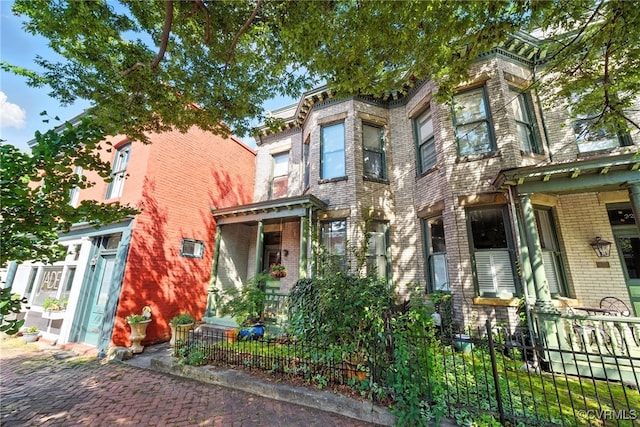 323 N 27th St, Richmond, VA 23223 - italianate home featuring brick siding and a fenced front yard