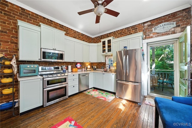 323 N 27th St, Richmond, VA 23223 - kitchen with appliances with stainless steel finishes, crown molding, light countertops, dark wood finished floors, and a ceiling fan