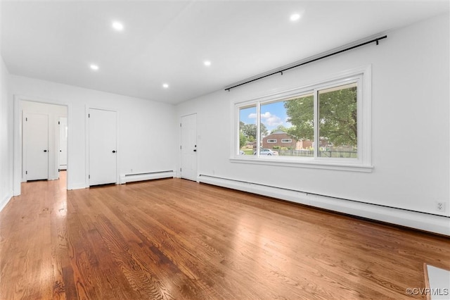 602 Trellis Ln, Henrico, VA 23075 - spare room featuring a baseboard heating unit, wood finished floors, and recessed lighting