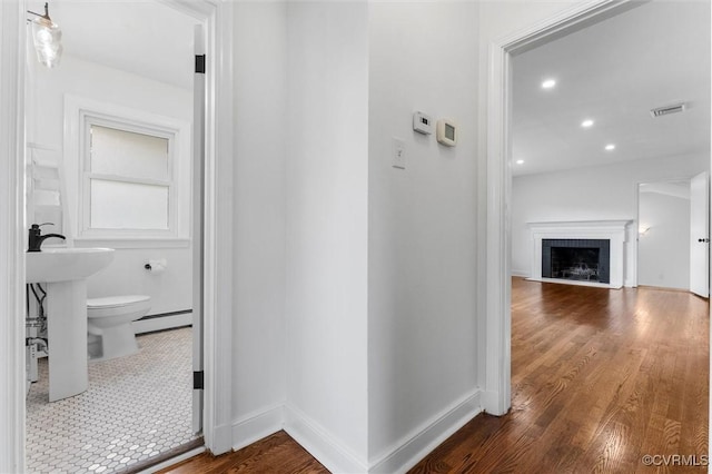 602 Trellis Ln, Henrico, VA 23075 - hall featuring a baseboard heating unit, dark wood-type flooring, and baseboards