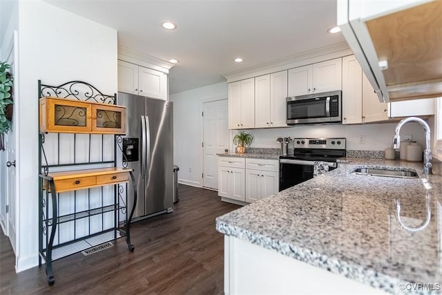 203 Pointers Dr, West Point, VA 23181 - kitchen with stainless steel appliances, a sink, white cabinets, dark wood-style floors, and recessed lighting