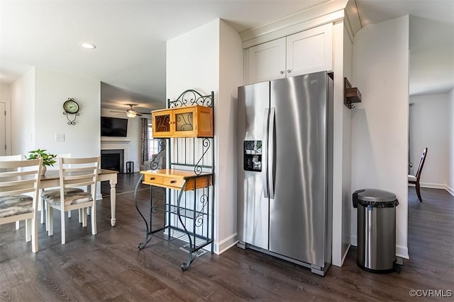 203 Pointers Dr, West Point, VA 23181 - kitchen with stainless steel fridge, a ceiling fan, dark wood-style floors, a fireplace, and baseboards