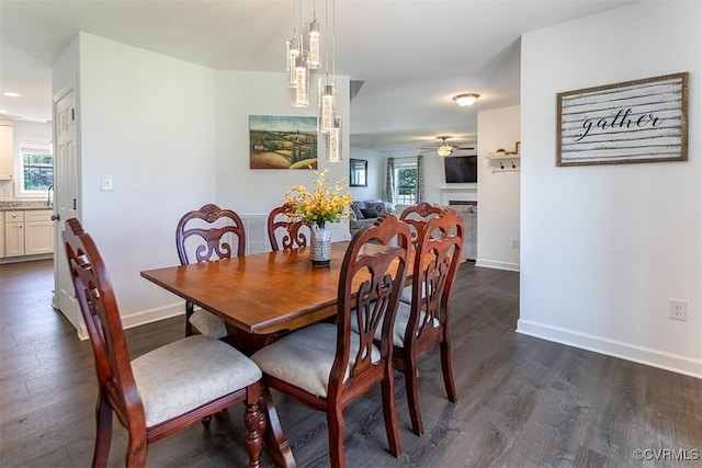 203 Pointers Dr, West Point, VA 23181 - dining area with dark wood-style flooring, ceiling fan, baseboards, and a fireplace