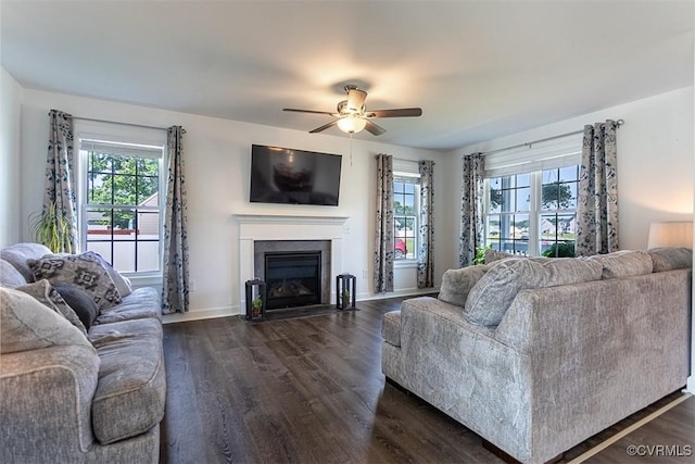 203 Pointers Dr, West Point, VA 23181 - living area with dark wood finished floors, a ceiling fan, a fireplace with flush hearth, and baseboards