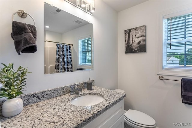 203 Pointers Dr, West Point, VA 23181 - bathroom featuring plenty of natural light, toilet, vanity, and curtained shower