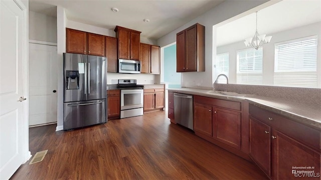 5324 Sandy Ridge Ct, Chesterfield, VA 23832 - kitchen featuring stainless steel appliances, dark wood-style floors, a chandelier, a sink, and hanging light fixtures
