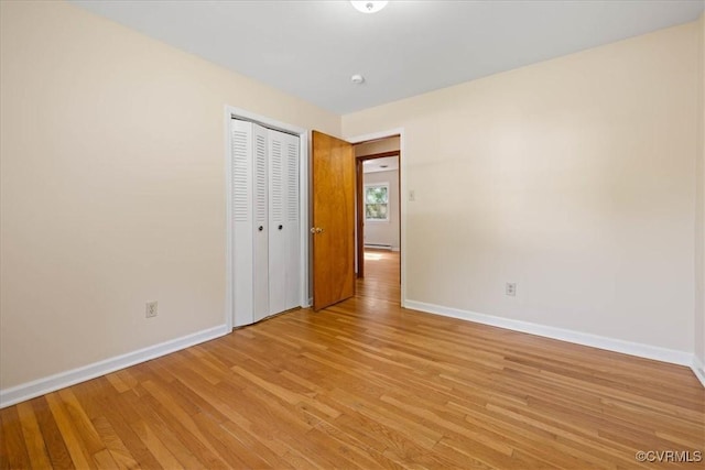 4200 Esposito Pl, Prince George, VA 23875 - unfurnished bedroom with baseboards, light wood-style flooring, a closet, and a baseboard heating unit