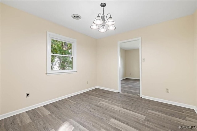 4200 Esposito Pl, Prince George, VA 23875 - empty room featuring a chandelier, wood finished floors, and baseboards